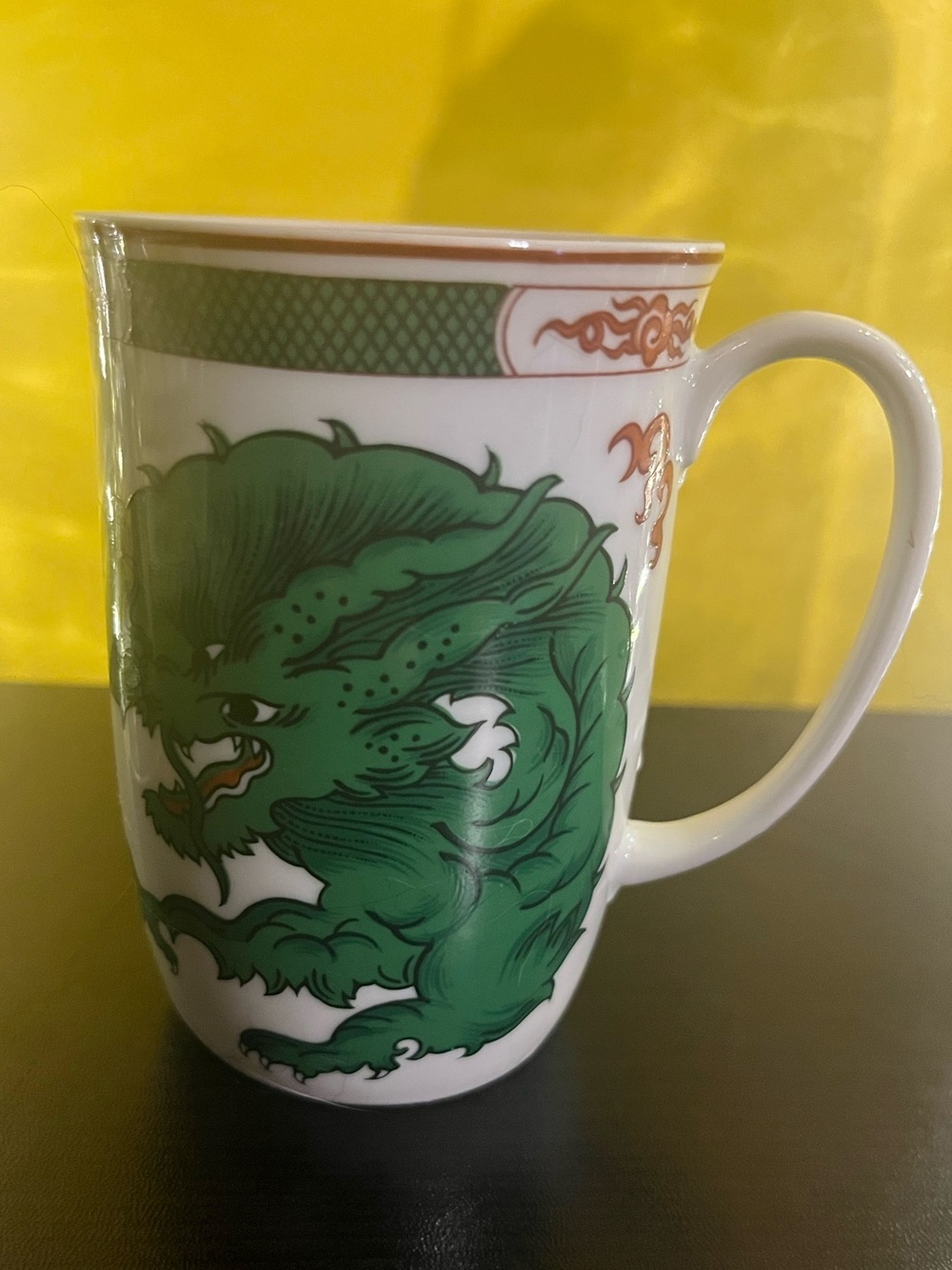 Fitz & Floyd Dragon Crest green porcelain mug features a distinctive dragon.